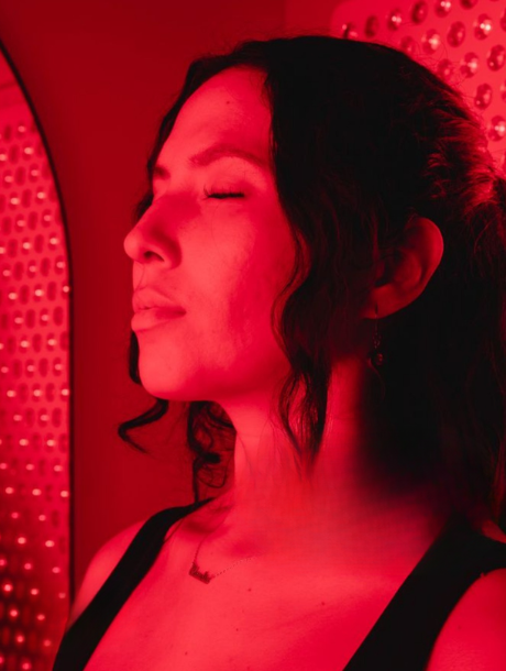 Woman relaxing during red light therapy for muscle recovery session at dtXfy Philadelphia.